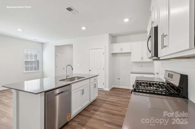 a kitchen with sink and cabinets