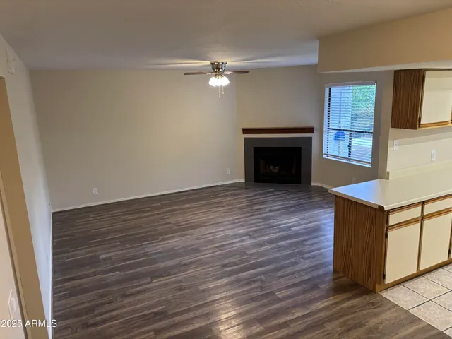 wooden floor fireplace and windows in an empty room