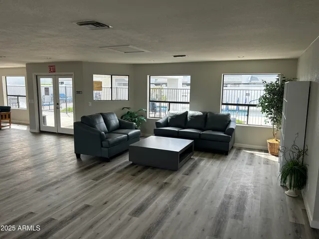 a room with lots of furniture and wooden floors