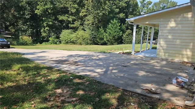 a view of a house with backyard and tree