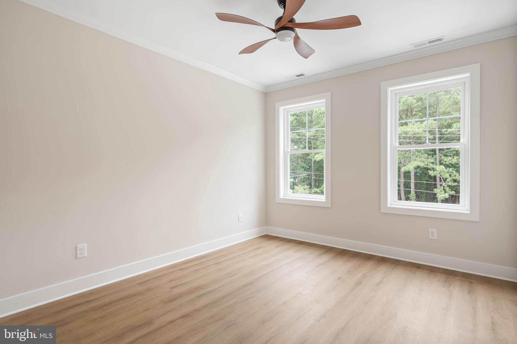 38697 Fred Hudson Road Bethany Beach, DE 19930 - Photo 48 of 51 an empty room with wooden floor fan and windows
