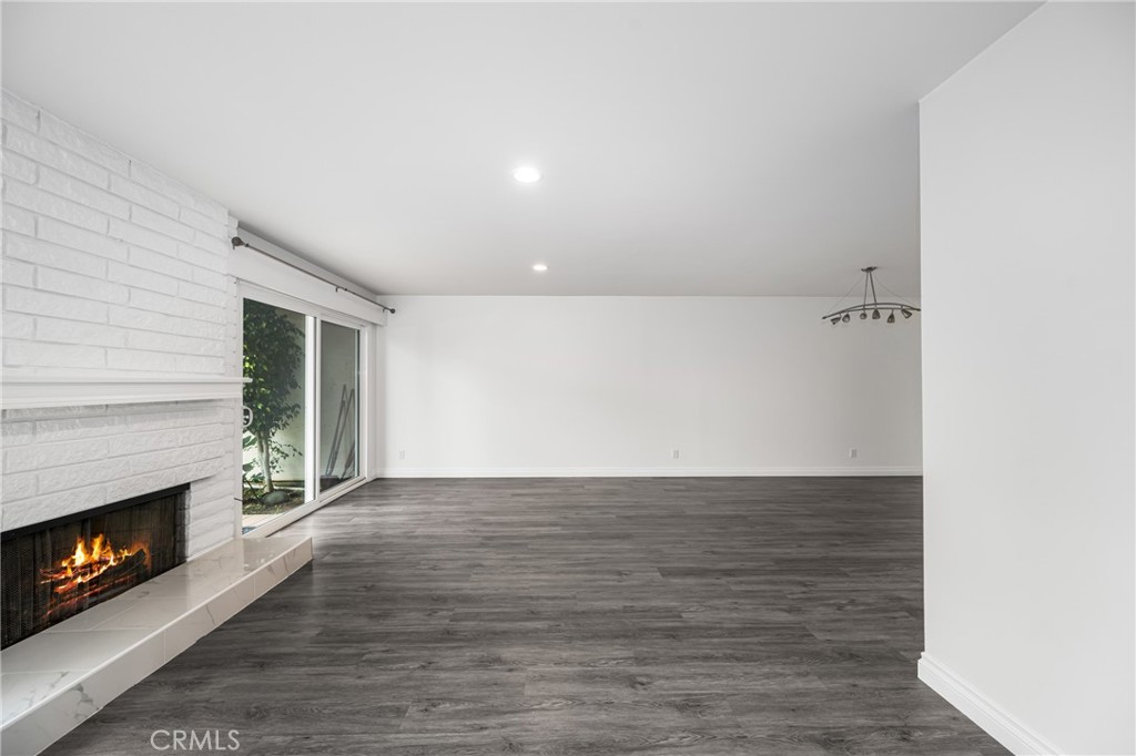96 Seton Road Irvine, CA 92612 - Photo 12 of 35 a view of an empty room with wooden floor fireplace and a window