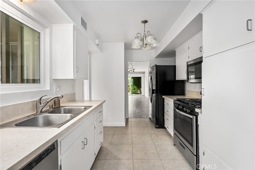 96 Seton Road Irvine, CA 92612 - Photo 21 of 35 a kitchen with stainless steel appliances a sink stove and refrigerator