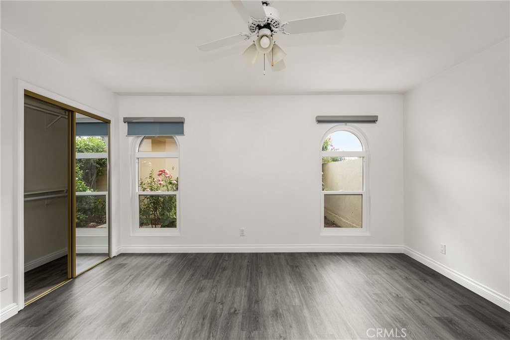 96 Seton Road Irvine, CA 92612 - Photo 25 of 35 an empty room with wooden floor cabinet and windows