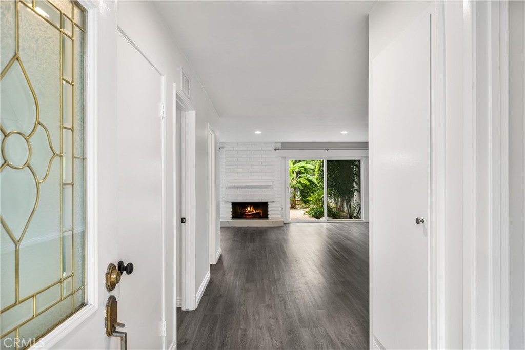 96 Seton Road Irvine, CA 92612 - Photo 7 of 35 a view of a hallway with wooden floor fireplace and windows