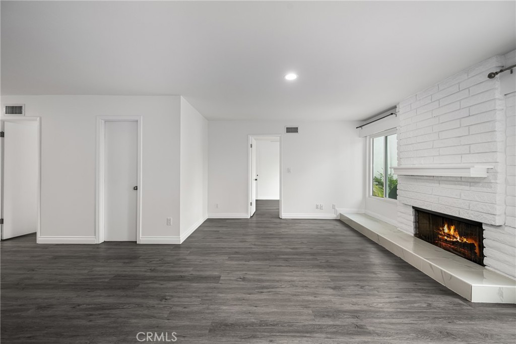 96 Seton Road Irvine, CA 92612 - Photo 10 of 35 a view of an empty room with wooden floor fireplace and a window