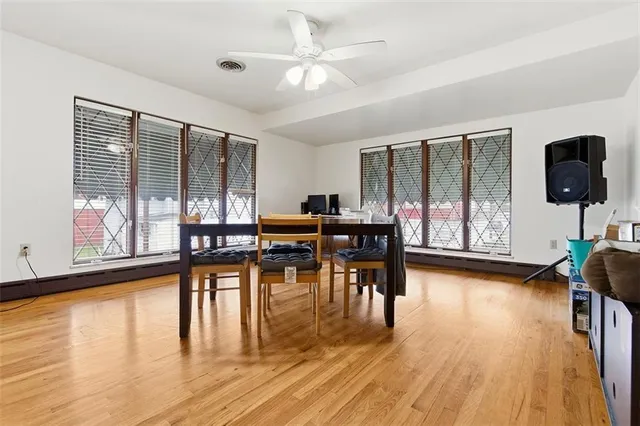 a living room with furniture and a large window with wooden floor