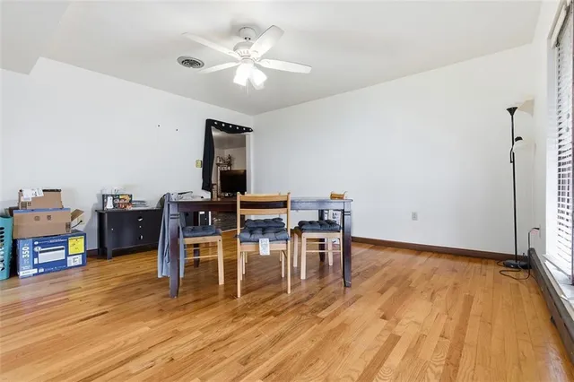 a view of a workspace with furniture and wooden floor