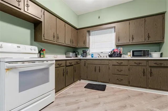 a kitchen with cabinets appliances and a sink