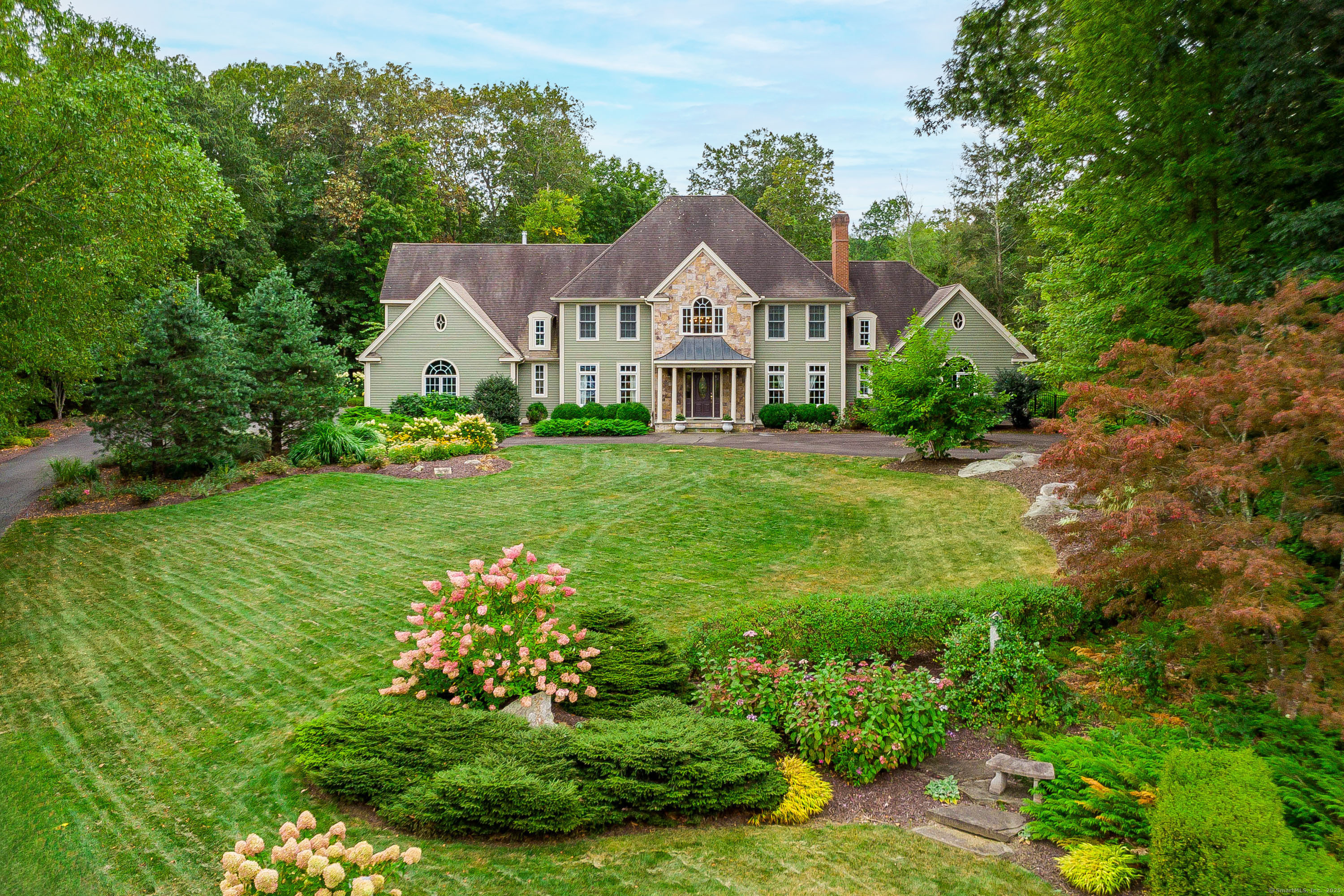 a front view of a house with garden