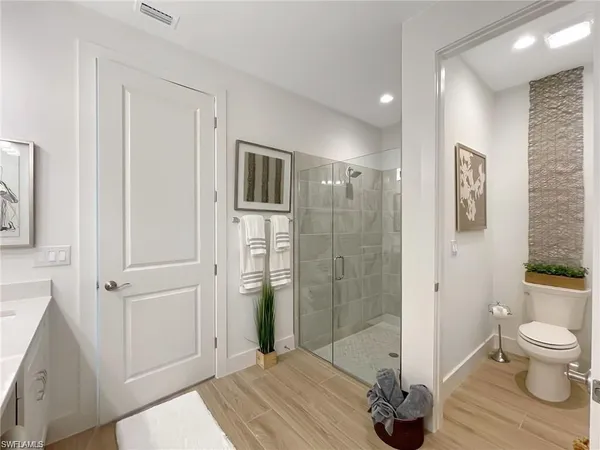 a bathroom with a sink a toilet and shower
