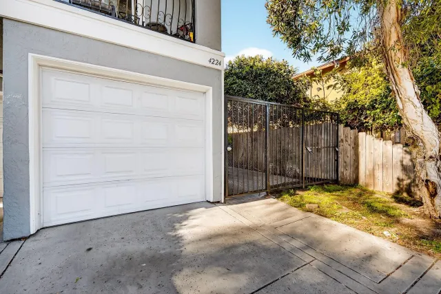 a view of backyard with wooden fence
