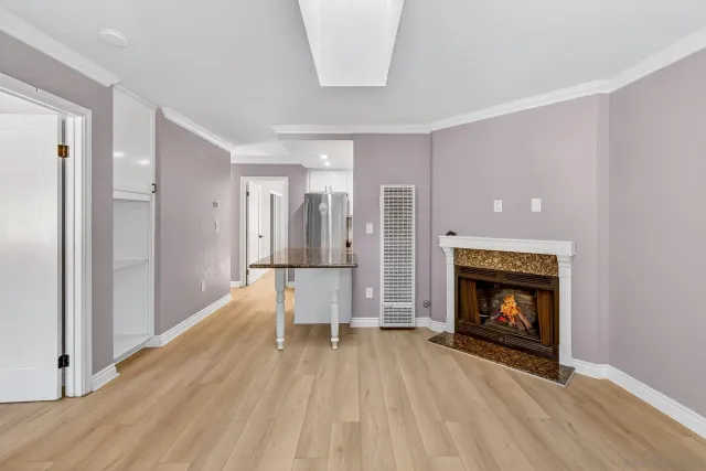 a view of an empty room with fire place and a fireplace