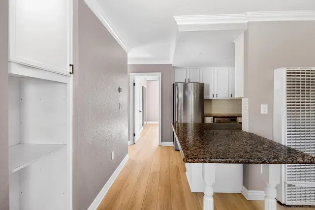 a kitchen with stainless steel appliances granite countertop a refrigerator and a sink