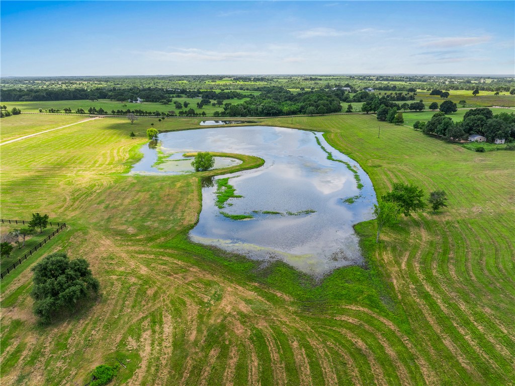 1725 Stokes Road New Ulm, TX 78950 - Photo 13 of 50 a view of a lake with a houses in the background
