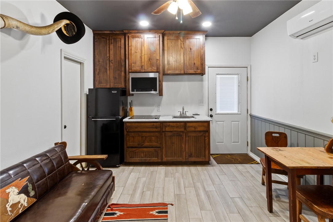 1725 Stokes Road New Ulm, TX 78950 - Photo 17 of 50 a kitchen with a refrigerator and a table