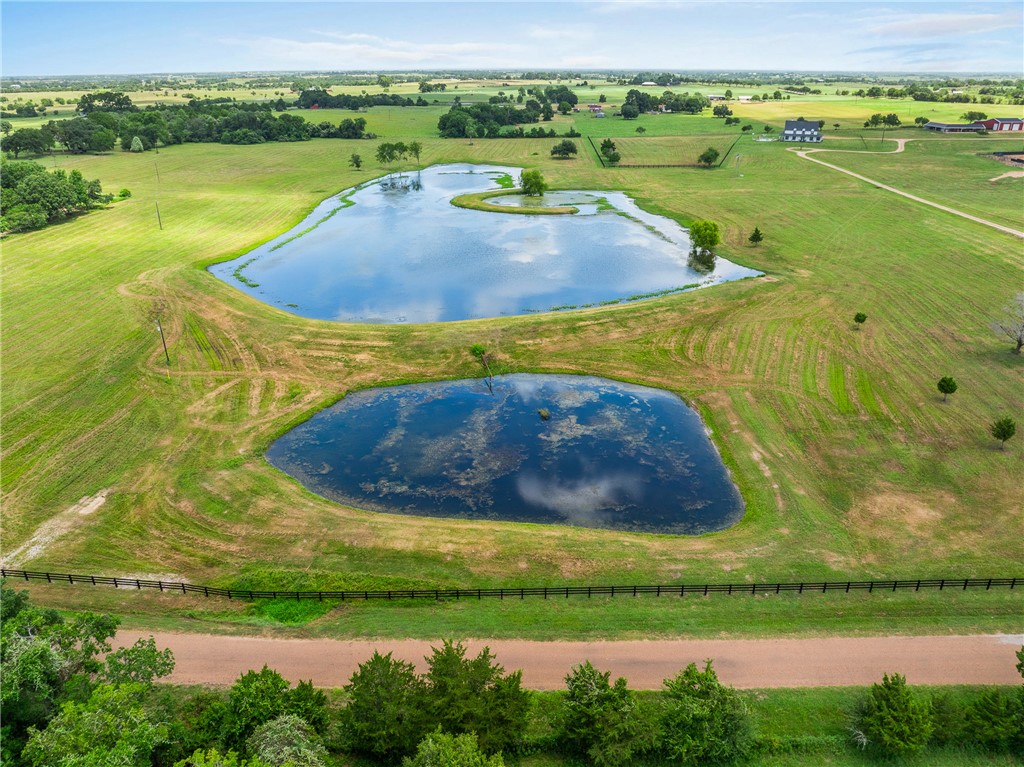 1725 Stokes Road New Ulm, TX 78950 - Photo 2 of 50 a view of a lake with a yard