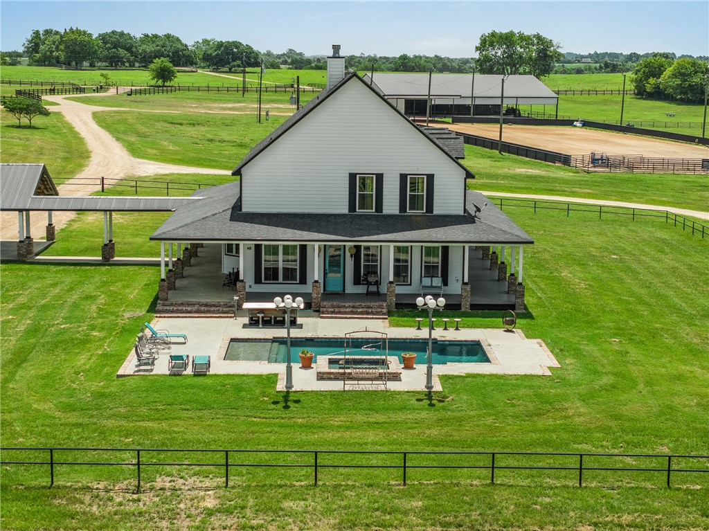 1725 Stokes Road New Ulm, TX 78950 - Photo 29 of 50 Rear view of house featuring an outdoor hangout area, a rural view, a patio area, and a lawn