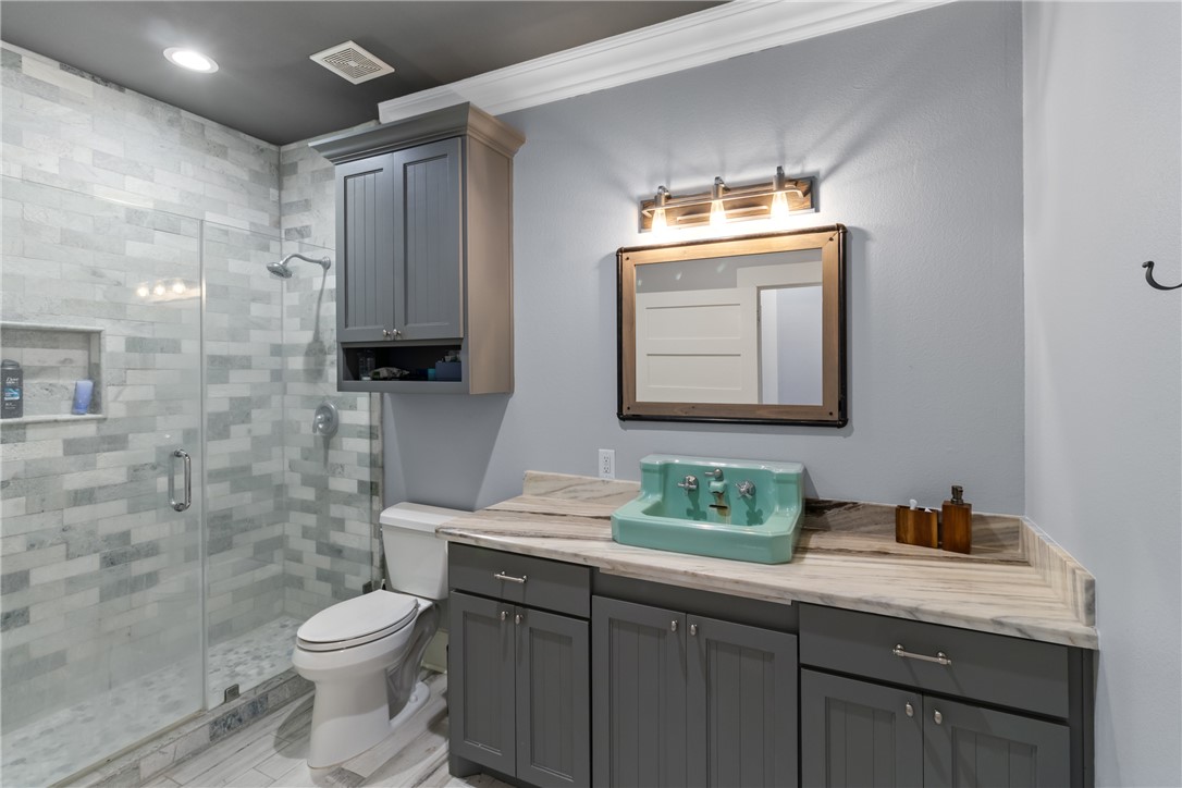 1725 Stokes Road New Ulm, TX 78950 - Photo 40 of 50 Bathroom with vanity, toilet, an enclosed shower, and crown molding