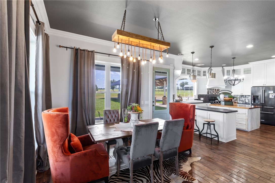 1725 Stokes Road New Ulm, TX 78950 - Photo 42 of 50 a dining room with furniture a chandelier and wooden floor