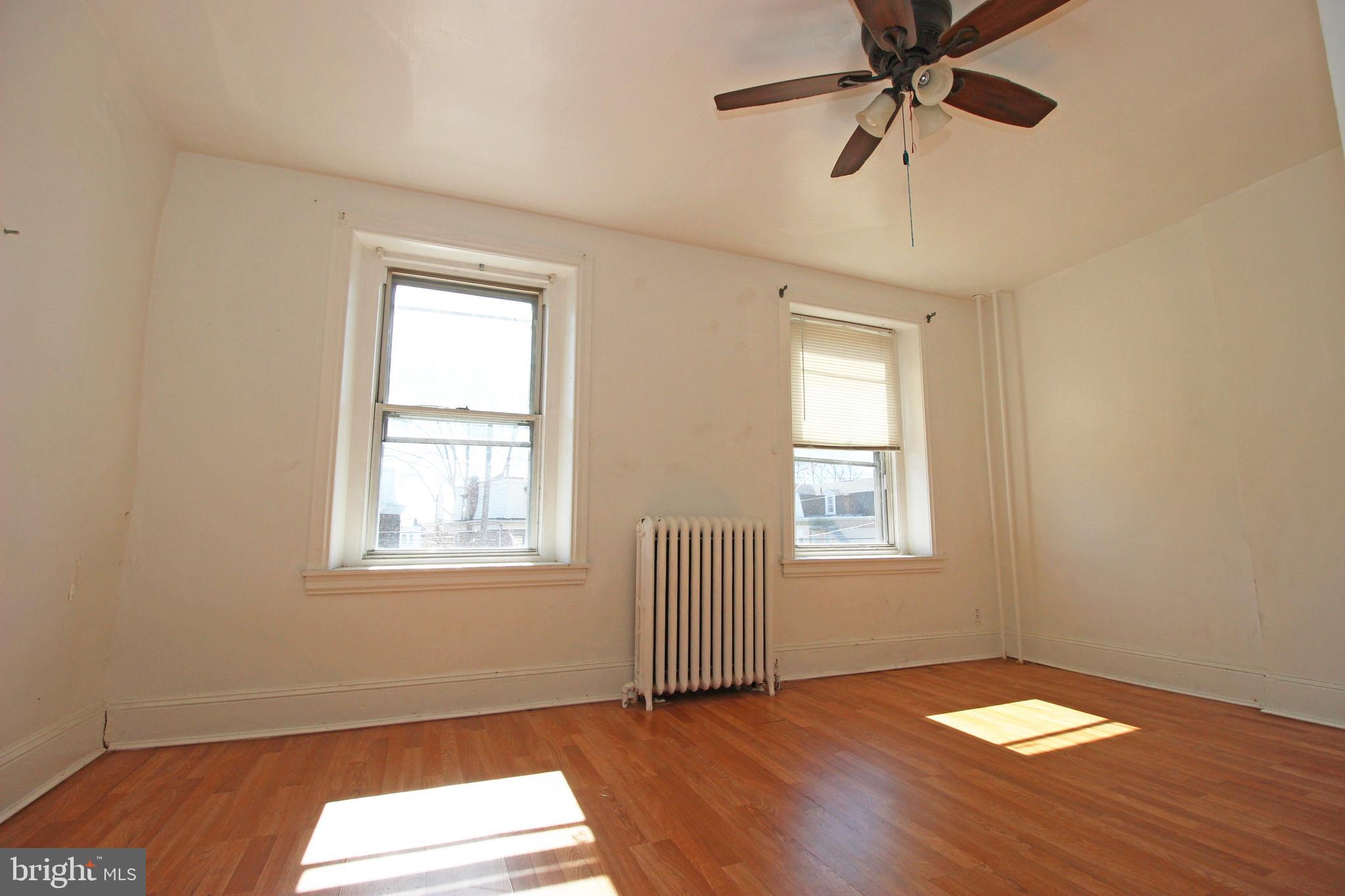 213 East Tabor Road Philadelphia, PA 19120 - Photo 24 of 106 a view of an empty room with wooden floor and window