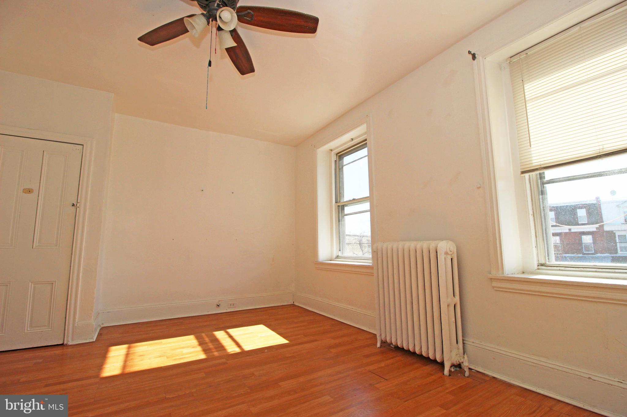 213 East Tabor Road Philadelphia, PA 19120 - Photo 27 of 106 a view of an empty room with a window and wooden floor