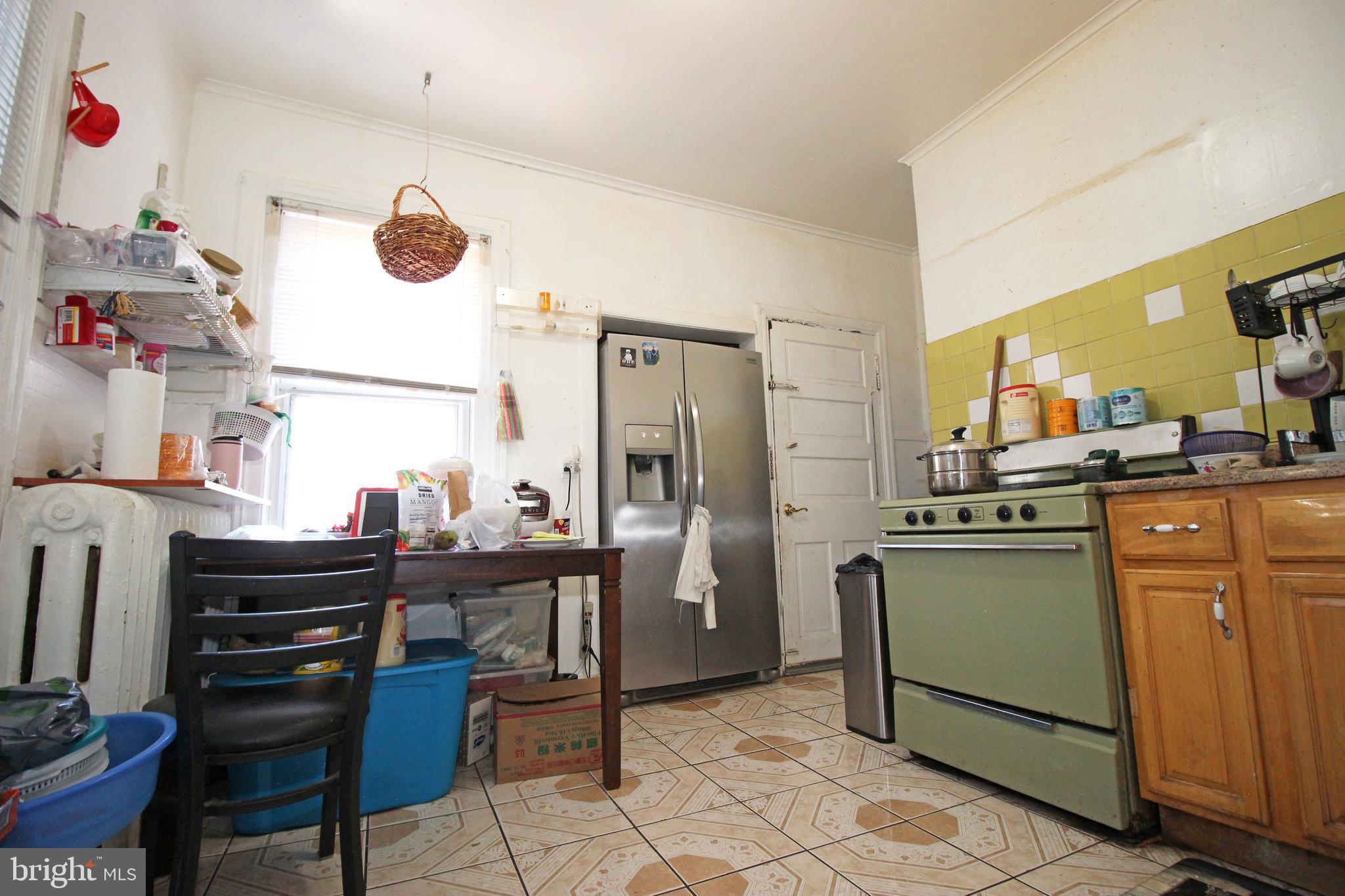213 East Tabor Road Philadelphia, PA 19120 - Photo 65 of 106 a kitchen with a sink and a stove top oven