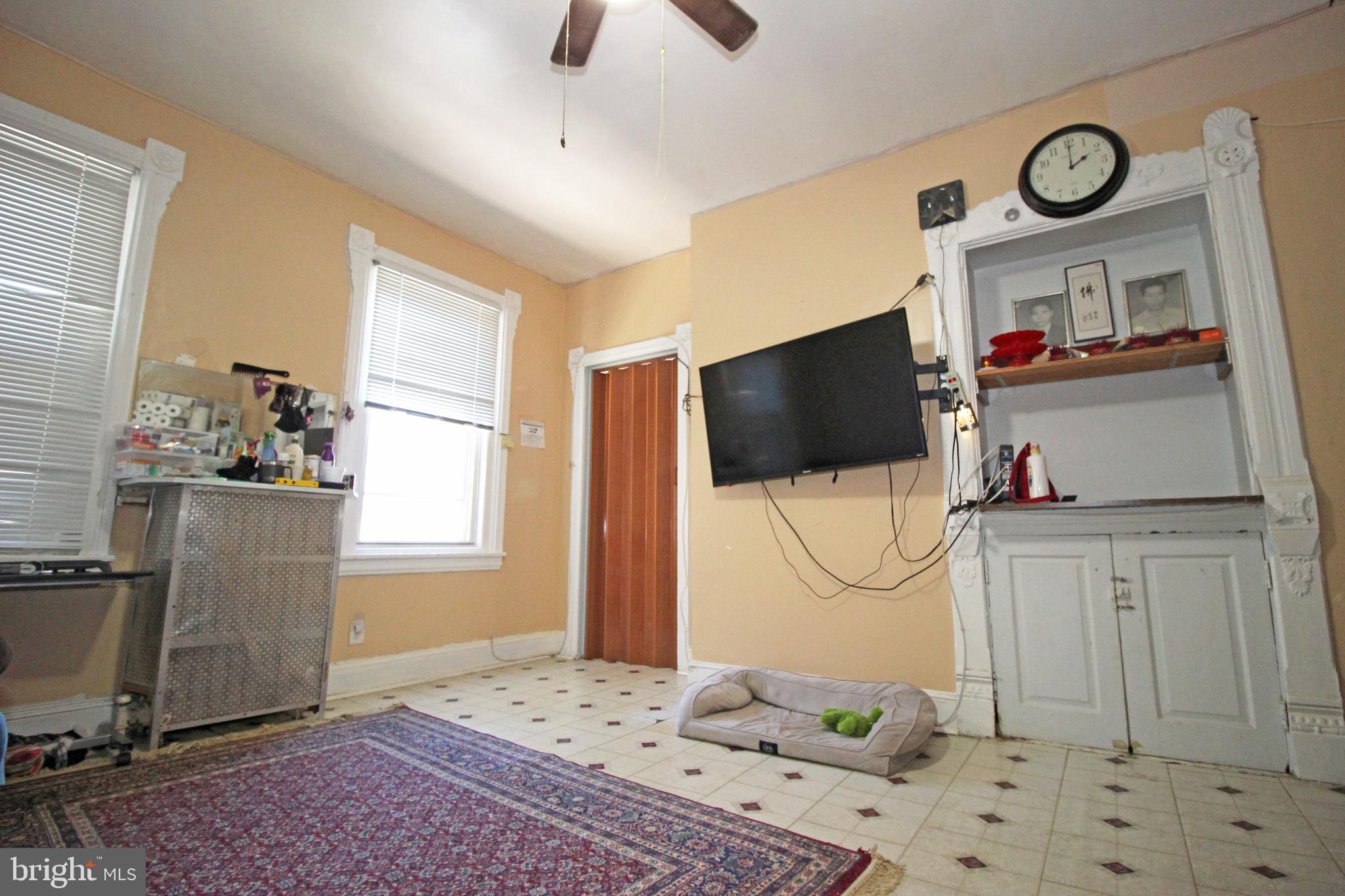 213 East Tabor Road Philadelphia, PA 19120 - Photo 77 of 106 a living room with a flat screen tv and a window