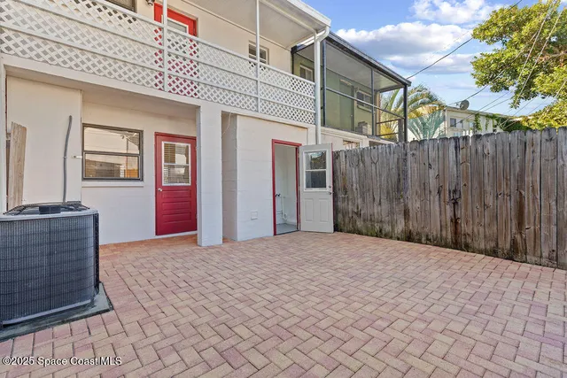 a front view of a house with a garden and trees