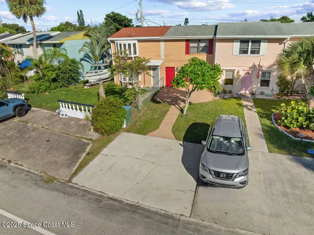 an aerial view of residential building with parking