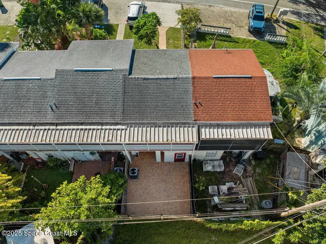 an aerial view of residential houses with city view