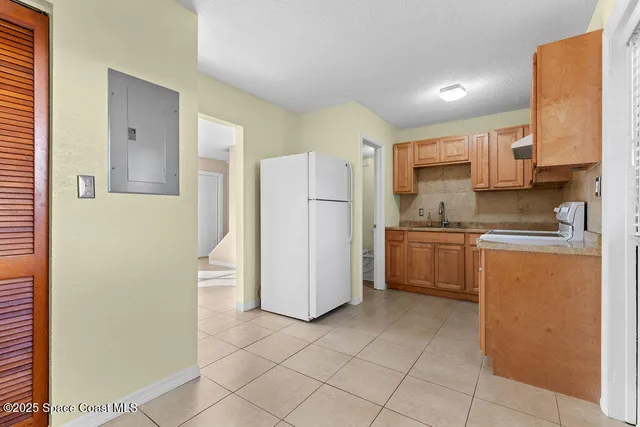 a kitchen with stainless steel appliances granite countertop a refrigerator sink and cabinets