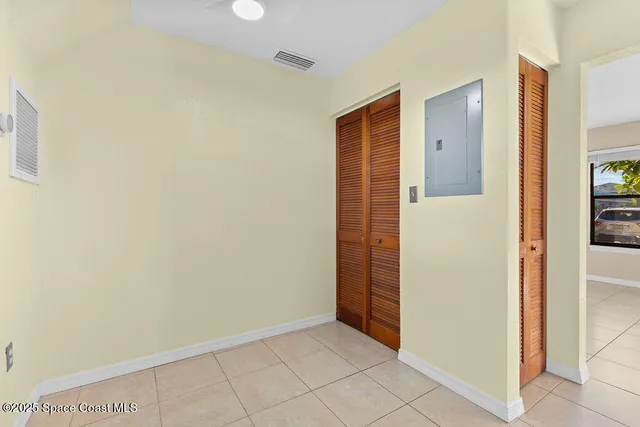 a white toilet sitting next to a white wall