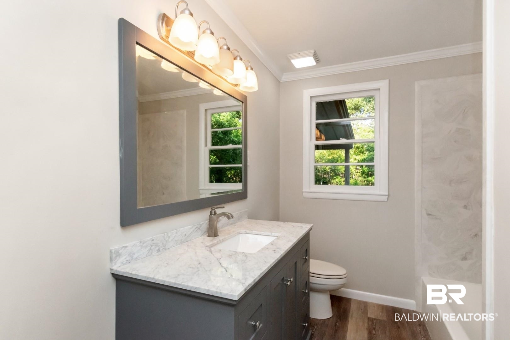 1220 Garland Drive Mobile, AL 36618 - Photo 17 of 25 Bathroom with ornamental molding, vanity, hardwood / wood-style floors, and toilet