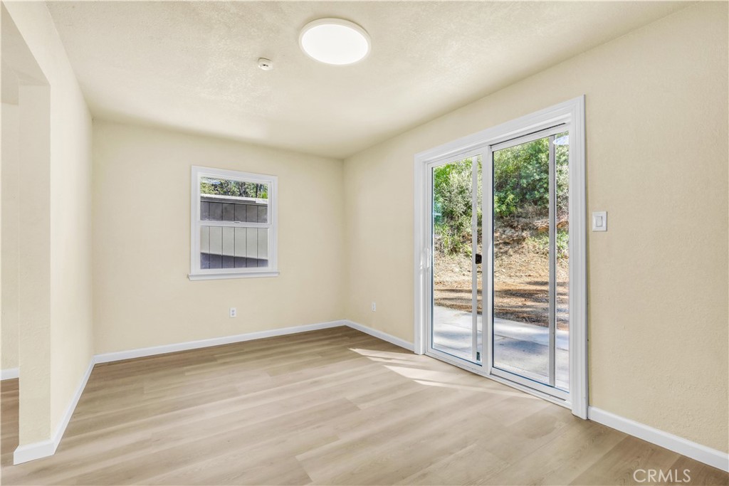 15905 Kugelman Street Lower Lake, CA 95457 - Photo 69 of 75 an empty room with wooden floor and windows