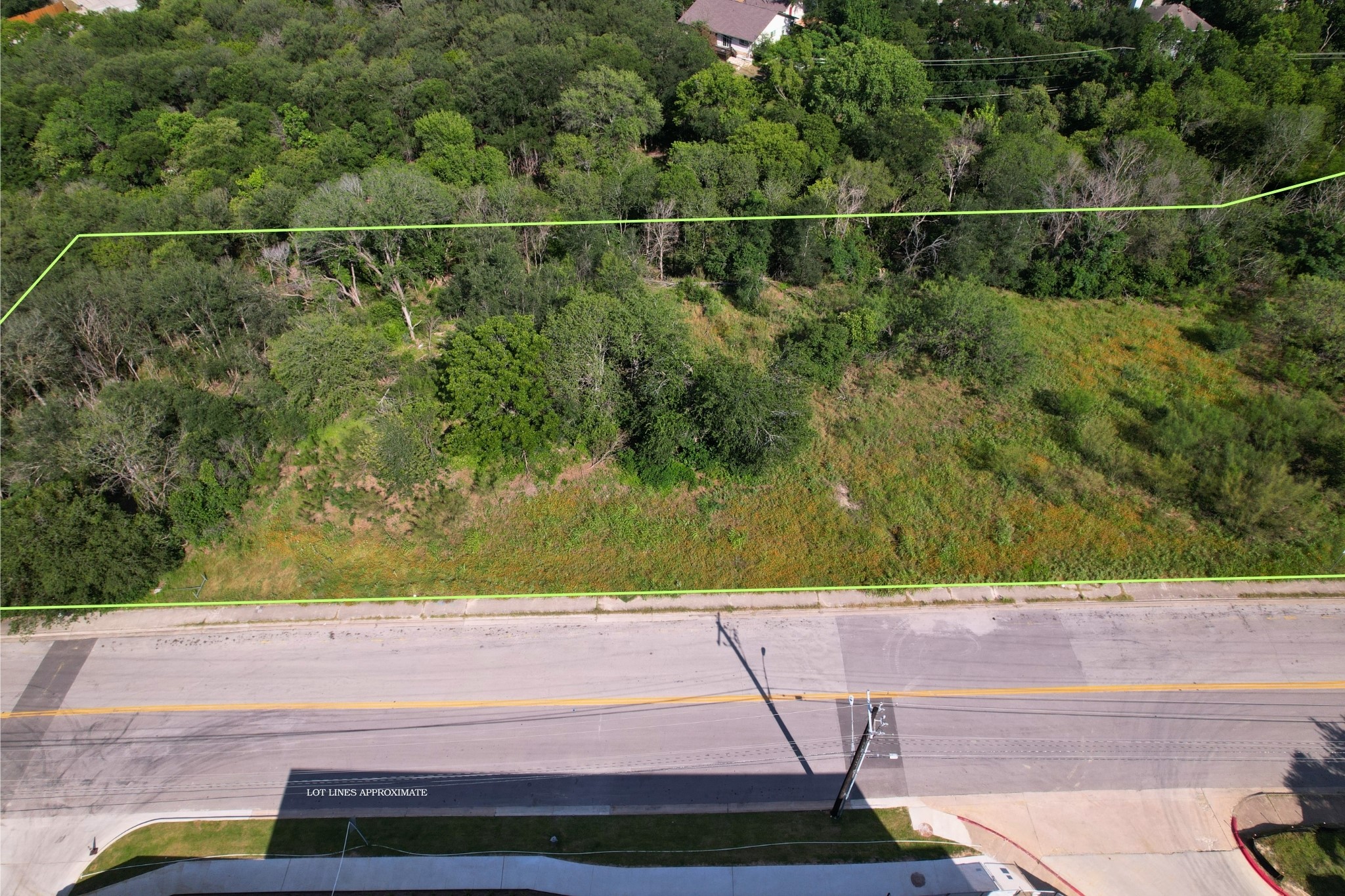 2813-2827 Metcalfe Road Austin, TX 78741 - Photo 7 of 13 A spacious, tree-lined lot awaits your vision, bordered by a well-maintained road. Backed by City owned creek land.