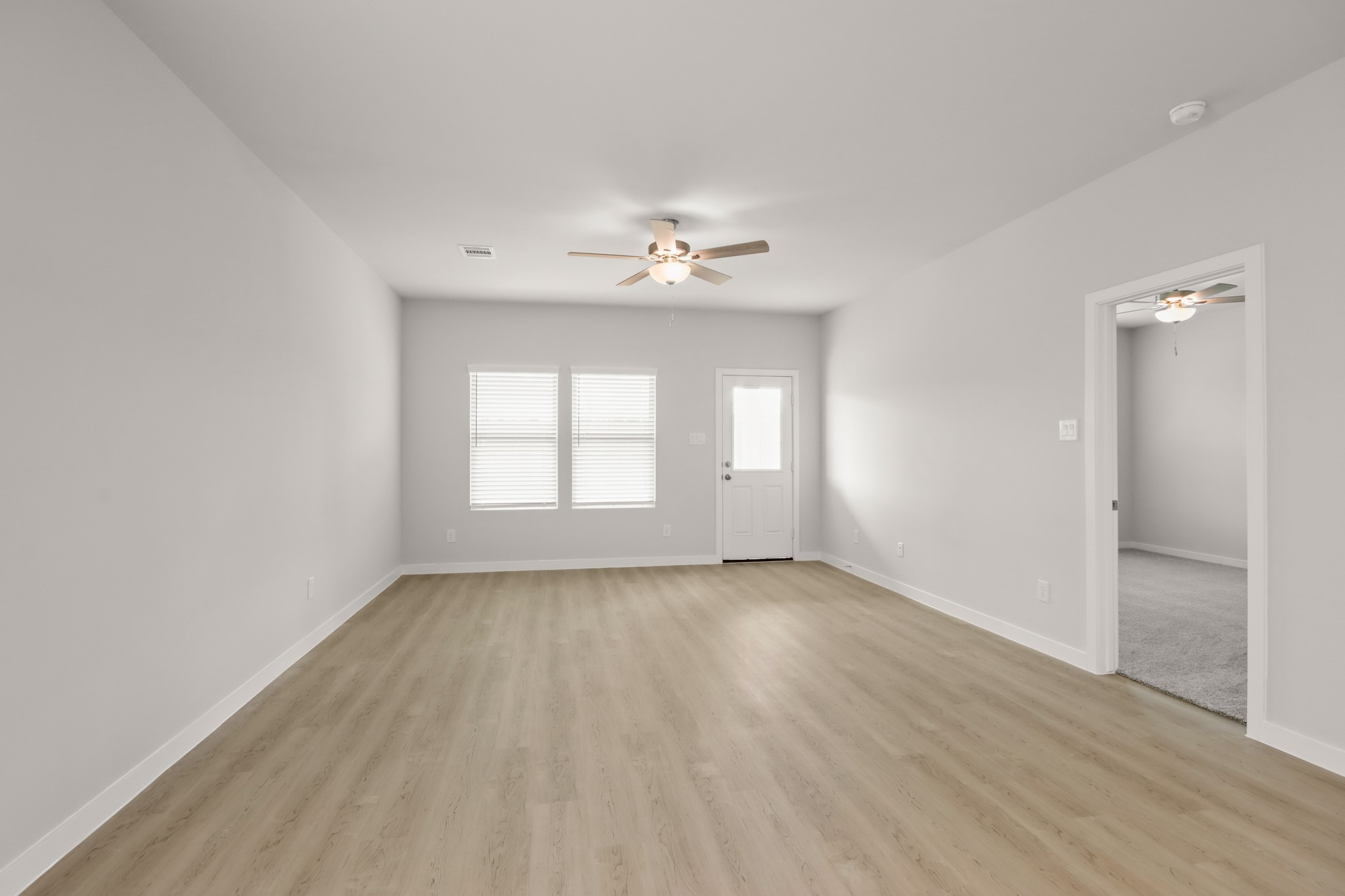 213 Spring Drive Hockley, TX 77447 - Photo 4 of 24 wooden floor in an empty room with a window