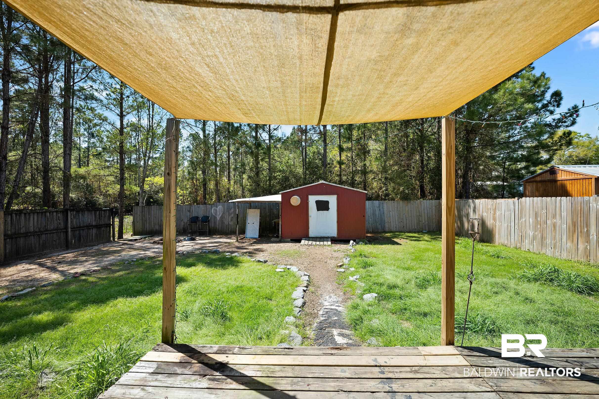 2000 Maria Lane Lillian, AL 36549 - Photo 16 of 35 Fenced backyard with a shed
