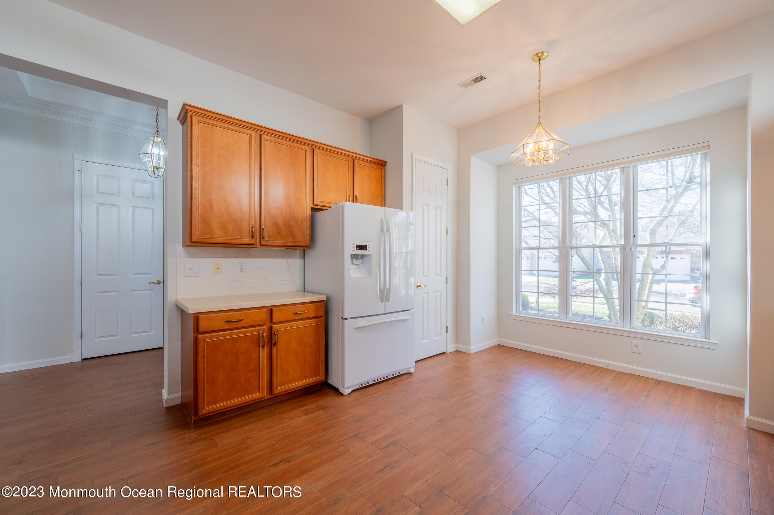27 Shoal Road Jackson, NJ 08527 - Photo 13 of 42 a open kitchen with stainless steel appliances granite countertop a stove a refrigerator a sink and dishwasher with wooden floor