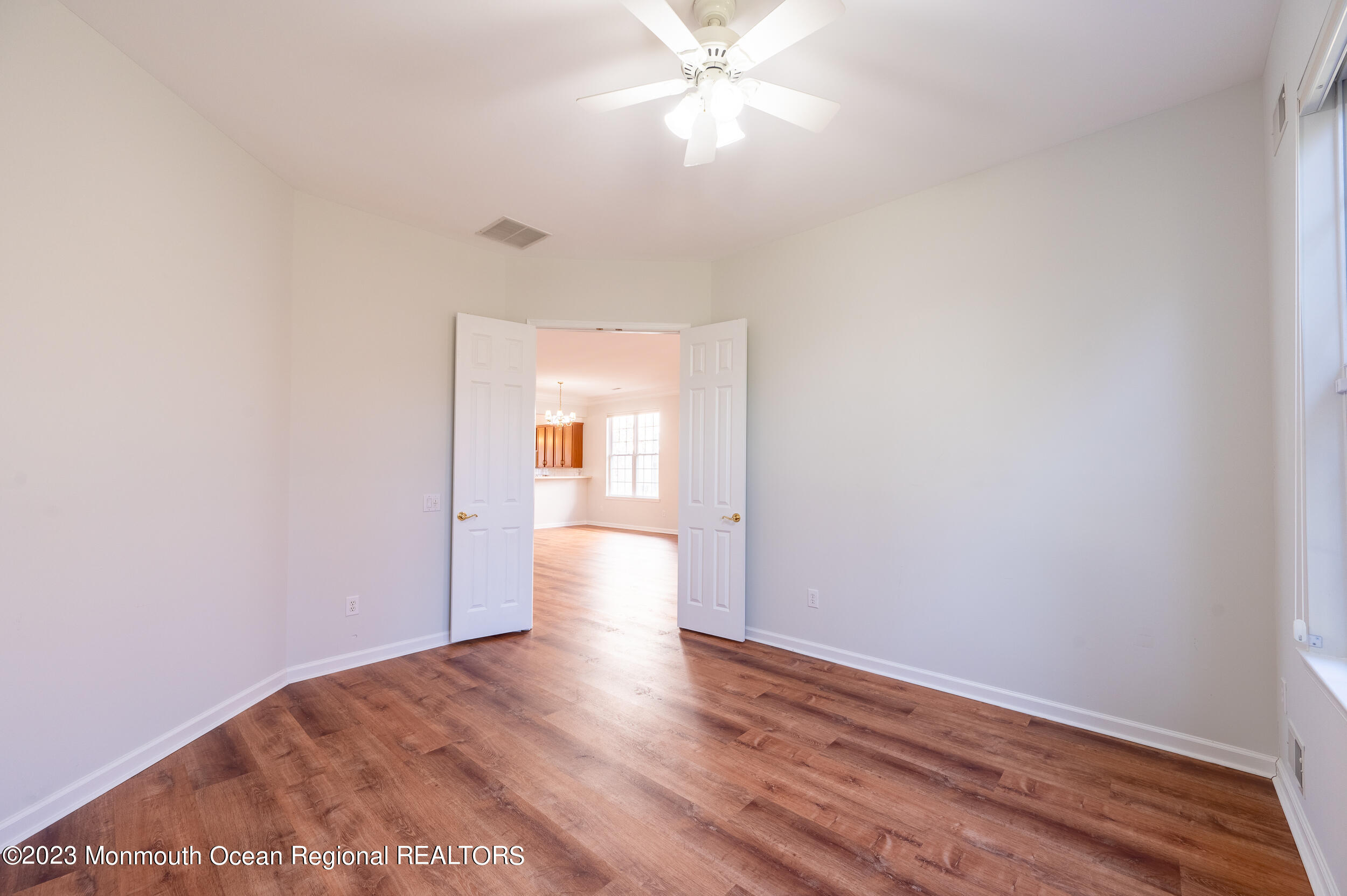 27 Shoal Road Jackson, NJ 08527 - Photo 21 of 42 a view of empty room with wooden floor and fan