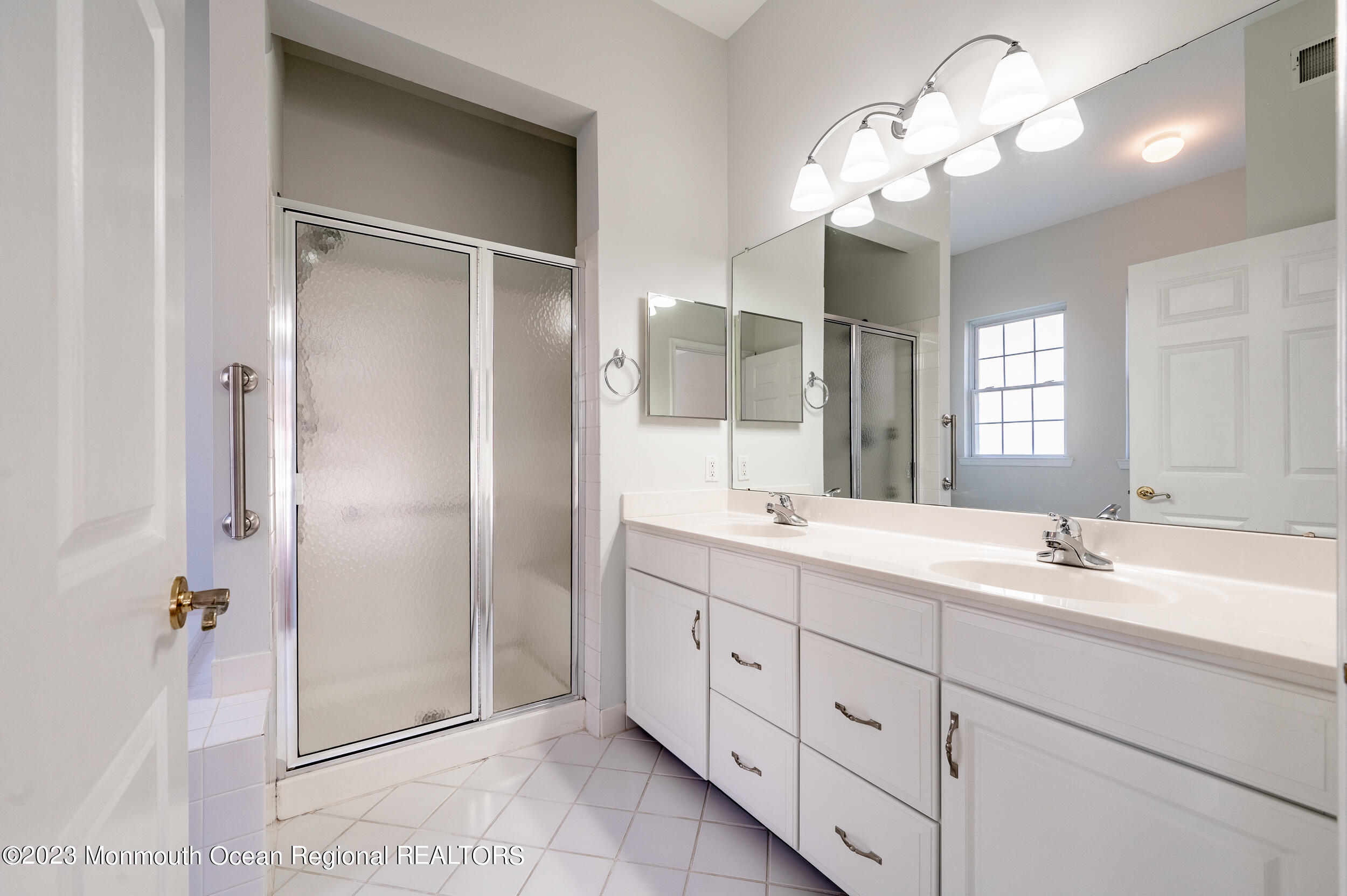 27 Shoal Road Jackson, NJ 08527 - Photo 25 of 42 a bathroom with a double vanity sink mirror and shower