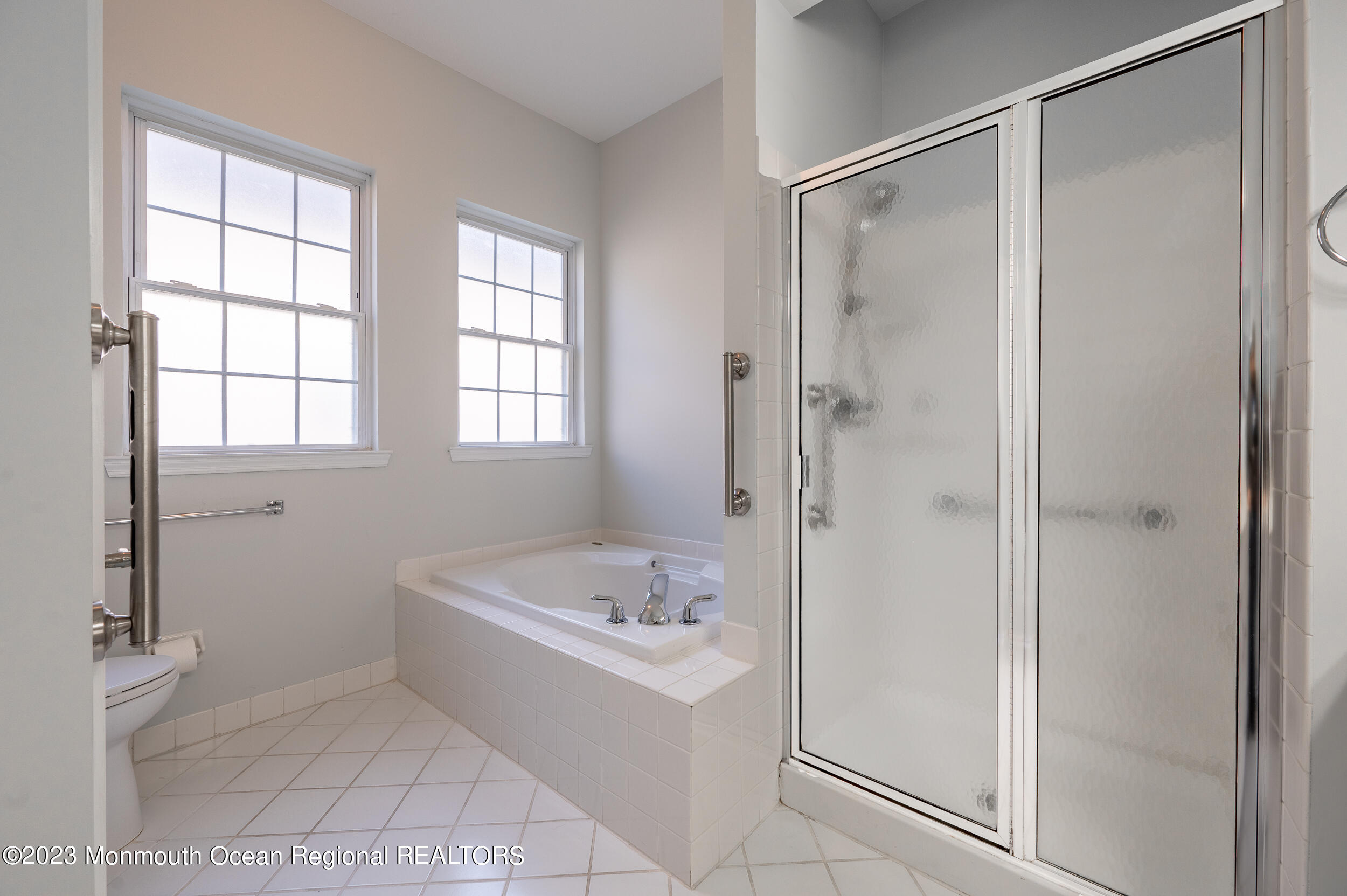 27 Shoal Road Jackson, NJ 08527 - Photo 27 of 42 a bathroom with a tub shower and window