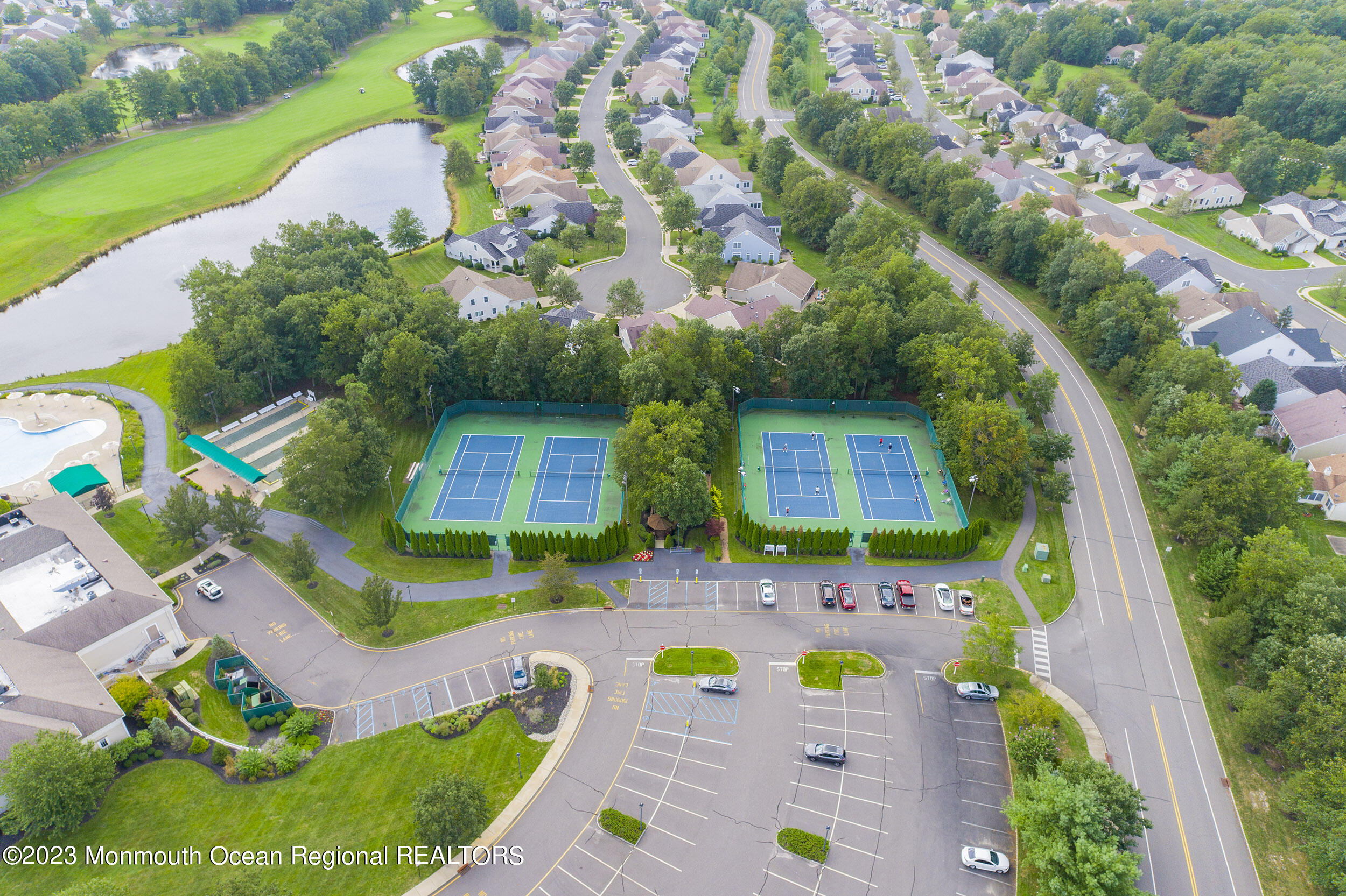 27 Shoal Road Jackson, NJ 08527 - Photo 42 of 42 an aerial view of a tennis ground and large trees