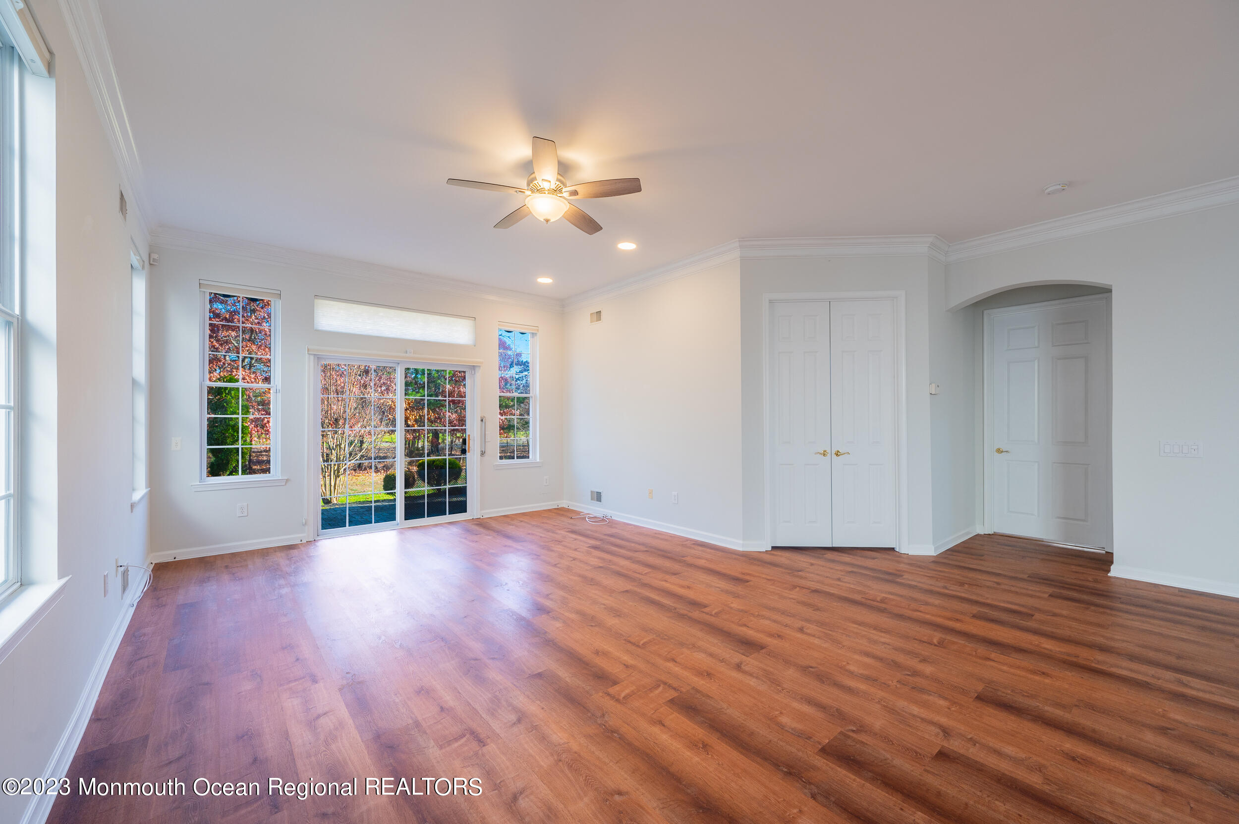27 Shoal Road Jackson, NJ 08527 - Photo 7 of 42 a view of an empty room with a window and wooden floor