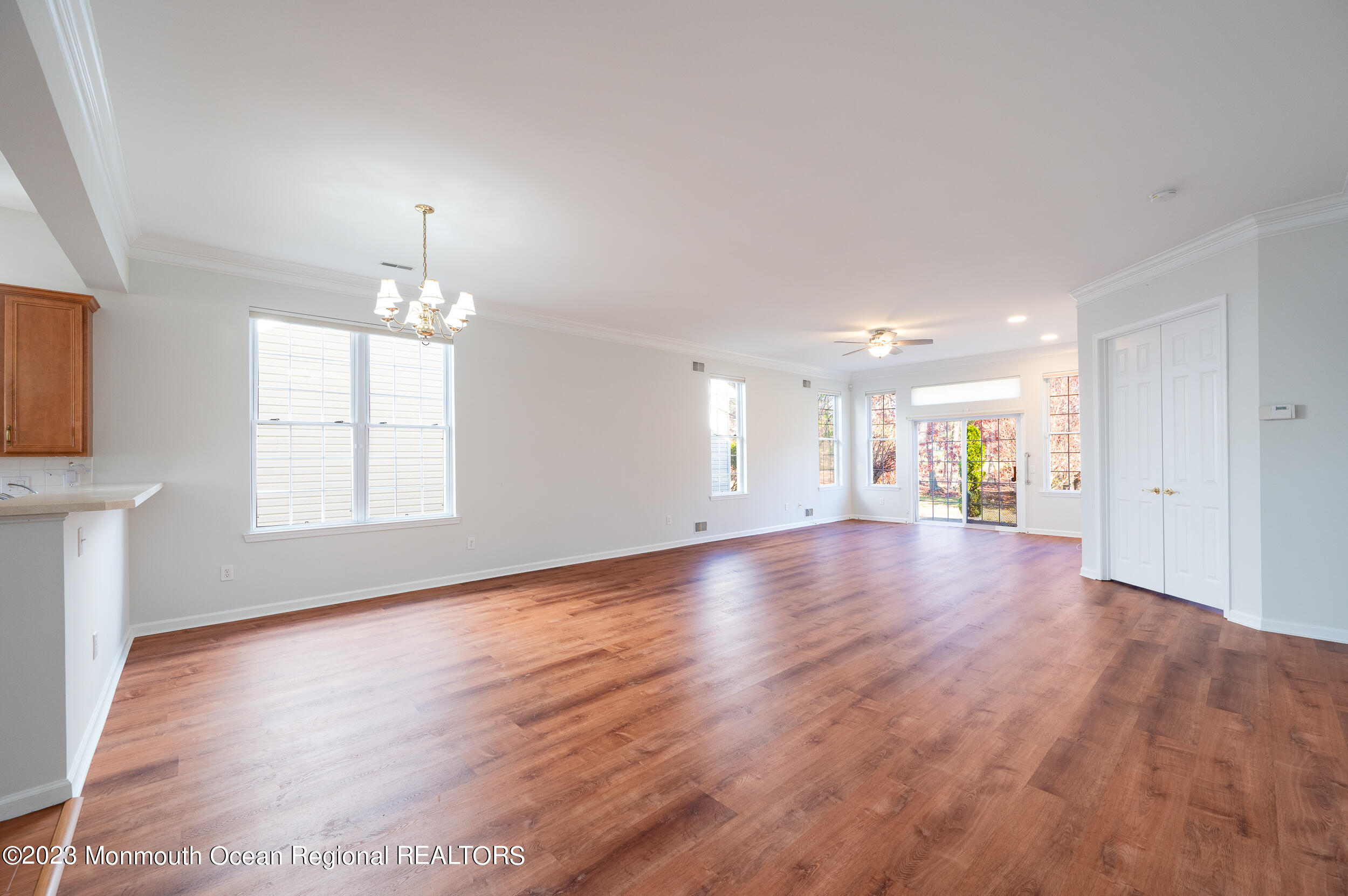 27 Shoal Road Jackson, NJ 08527 - Photo 8 of 42 a view of an empty room with window and wooden floor
