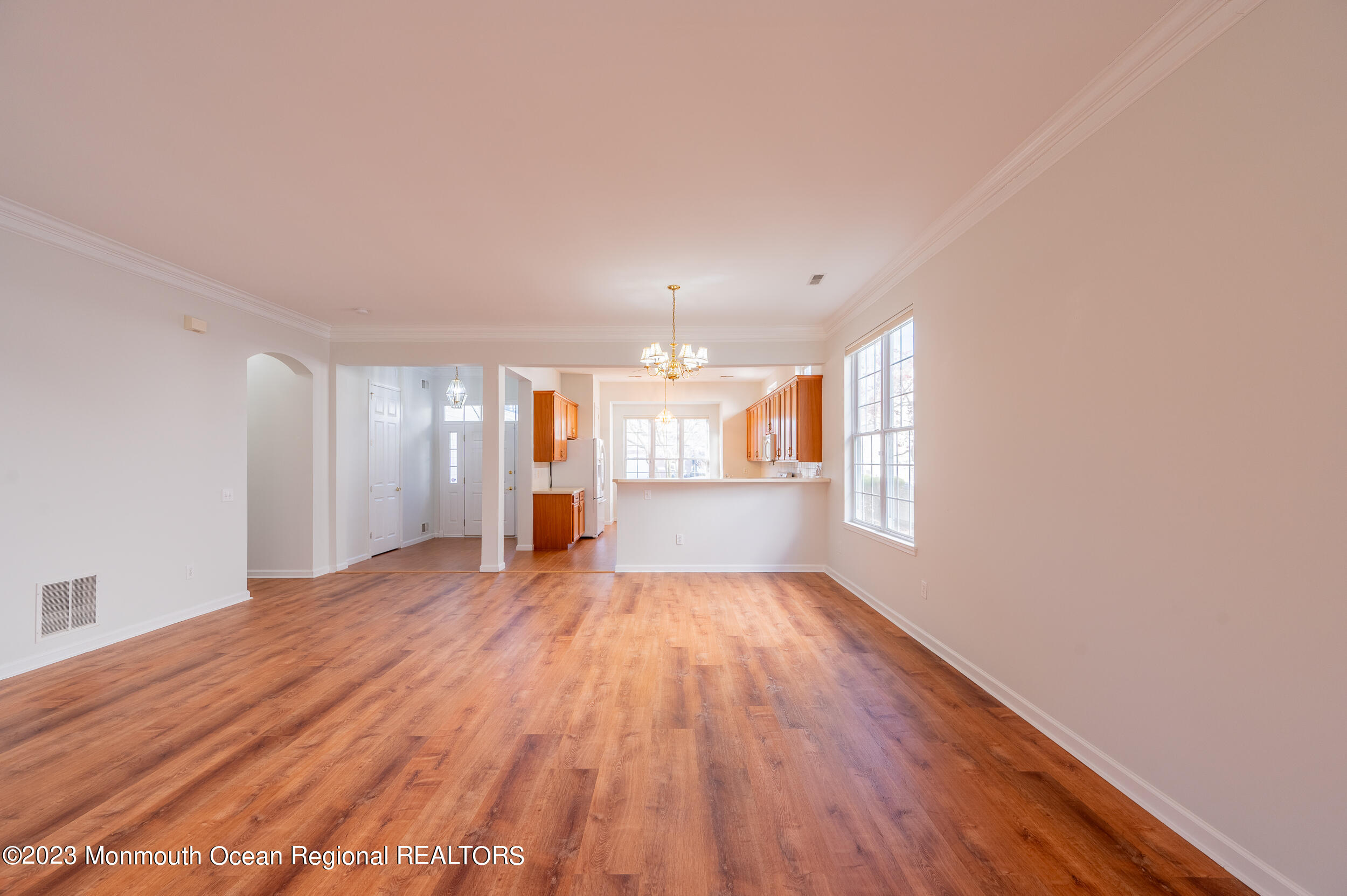 27 Shoal Road Jackson, NJ 08527 - Photo 9 of 42 a view of an empty room with wooden floor and a window
