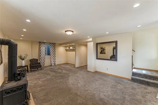 a view of a livingroom with furniture and a refrigerator
