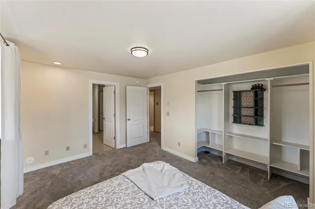 a bedroom with a rug and a window