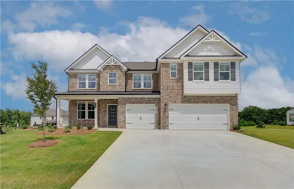 a front view of a house with a yard and garage