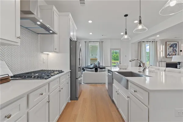 a large white kitchen with a large window
